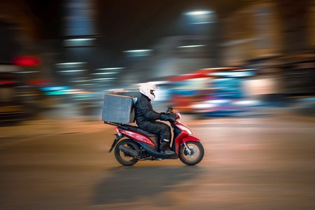 Man in a motorcycle delivery route